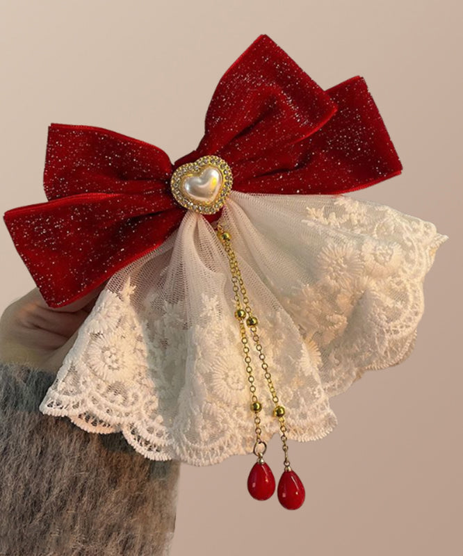 Épingle à cheveux en alliage de cristal avec pompon et nœud rouge élégant
