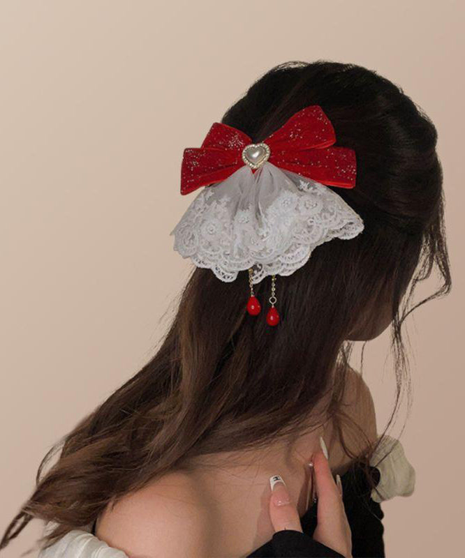 Épingle à cheveux en alliage de cristal avec pompon et nœud rouge élégant